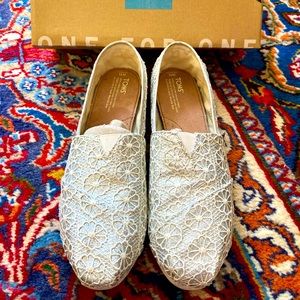 TOMS, Size 11. Silver with a Cream colored floral lace print overlay.